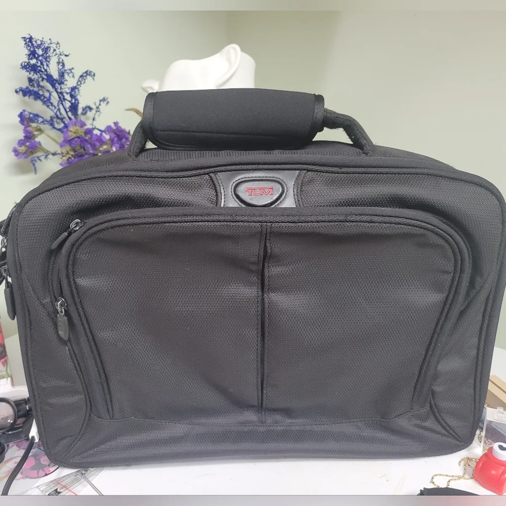 TUMI Black Backpack with Padded Straps and Multiple Compartments